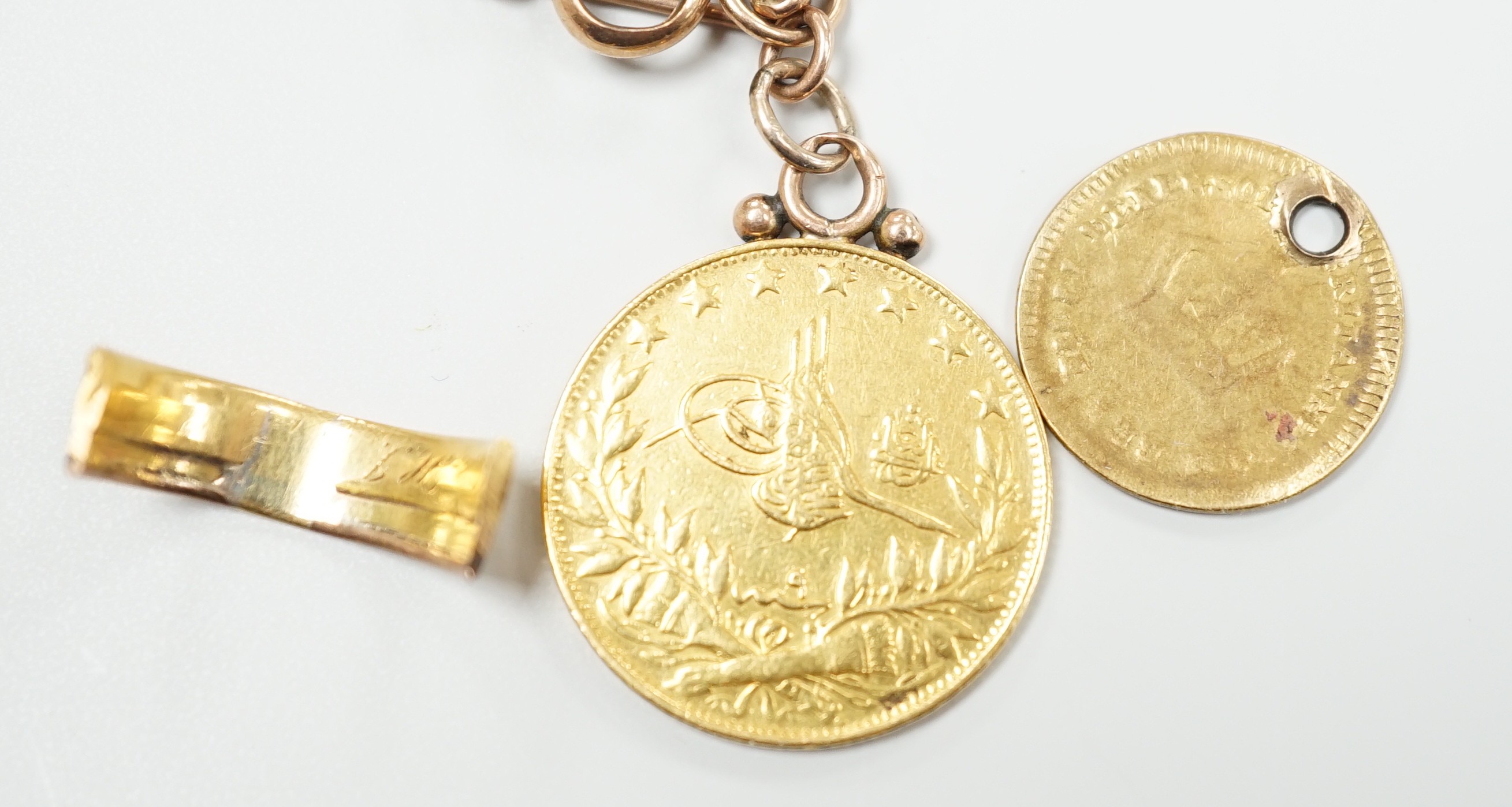 A Turkish 100 Karush gold coin, now mounted on a 9ct albert, chain 35cm, a gold one third guinea (worn and drilled) and a yellow metal shank section, gross weight 20.3 grams.